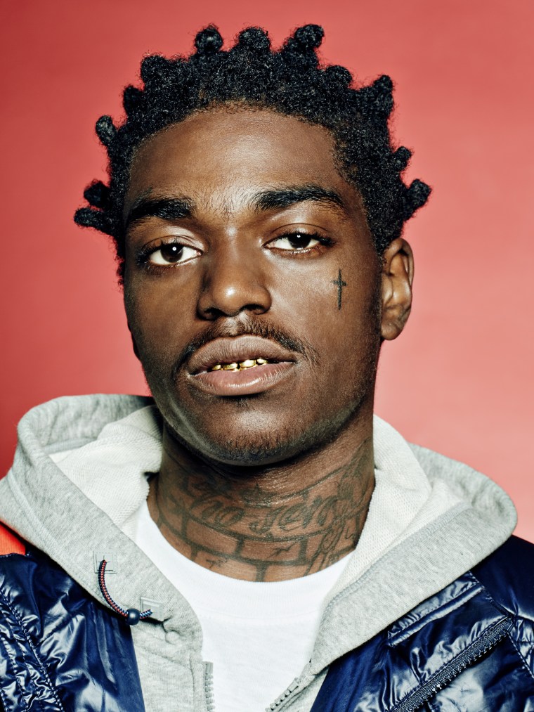 Kodak Black face cross tattoo in a close portrait