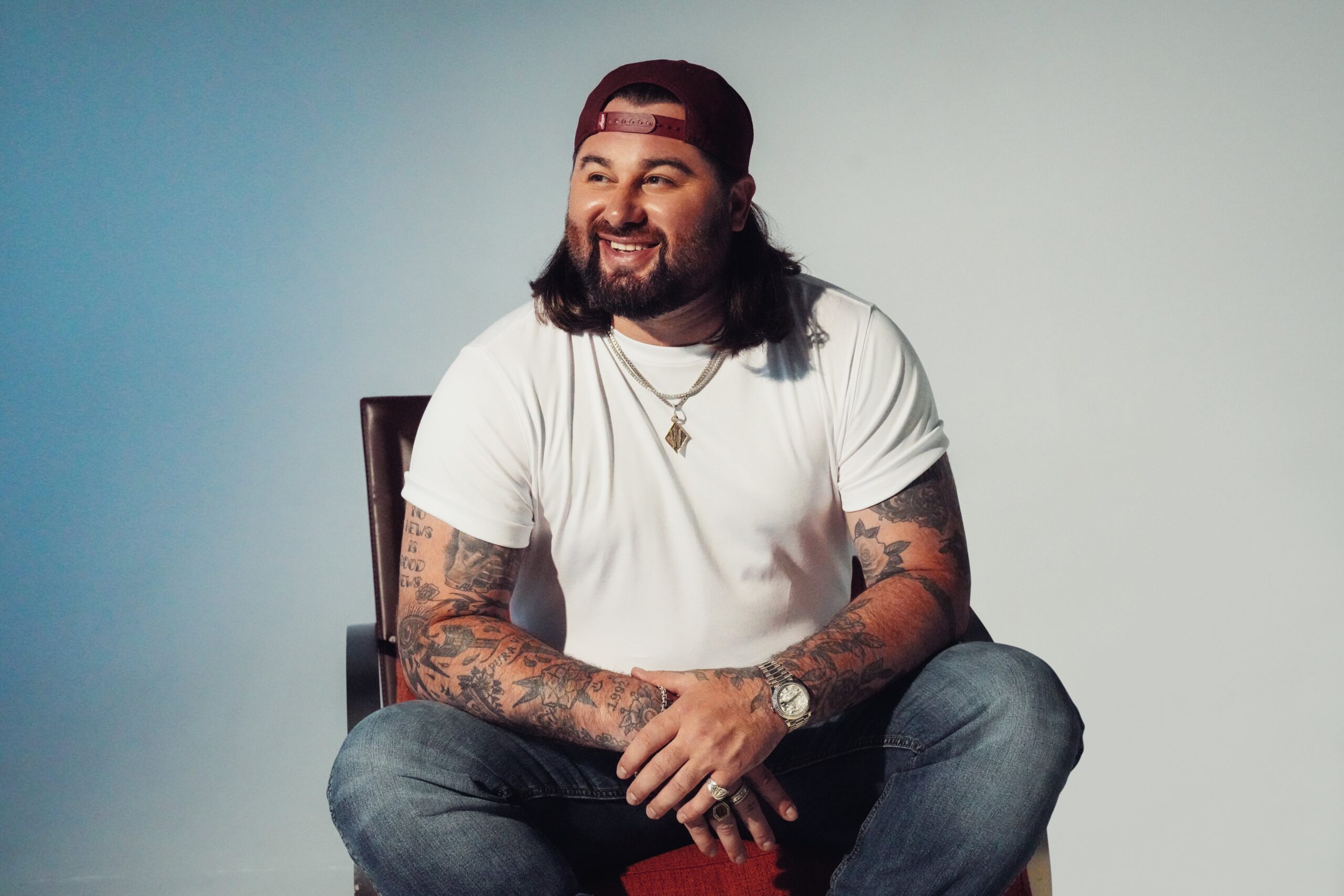 Koe Wetzel seated with visible arm tattoos