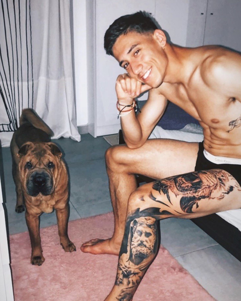 Konstantinos Tsimikas large visible leg tattoo work in a relaxed photograph with his dog Konstantinos Tsimikas tattoos: large visible leg tattoo work in a relaxed photograph with his dog