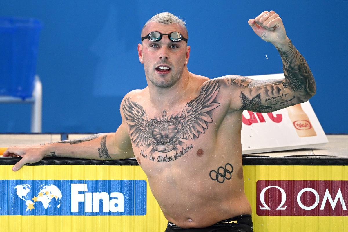 Kyle Chalmers tattoos: Wide competition view of the winged chest crown and phrase