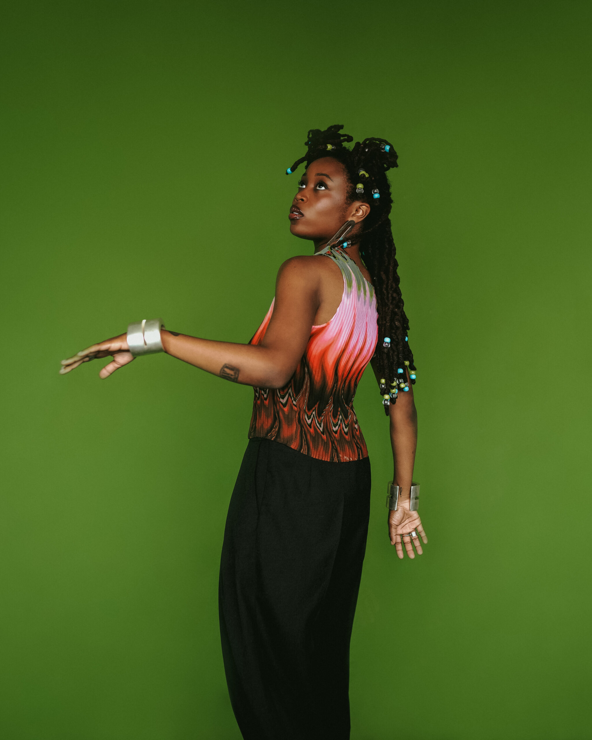 Lady Donli tattoos: Genuine tattoo photograph showing the visible arm collection at a natural portrait distance.