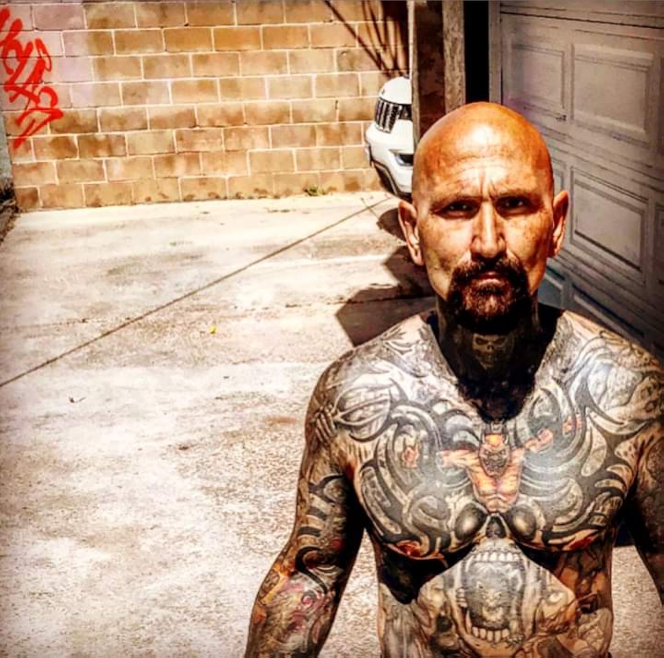 Robert LaSardo chest and arm tattoos