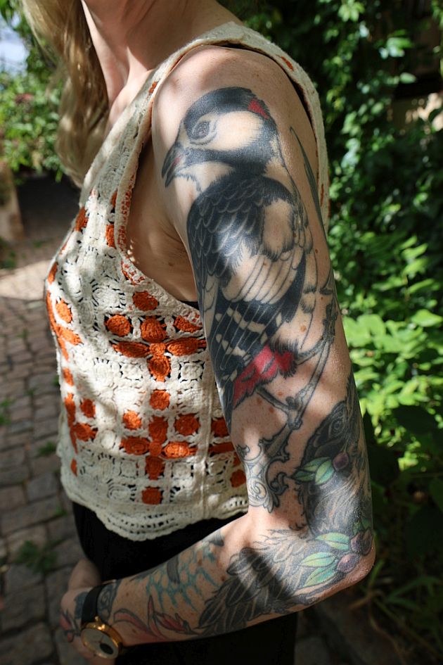 Laura Fella tattoos: The bird on Laura Fella's left-arm sleeve