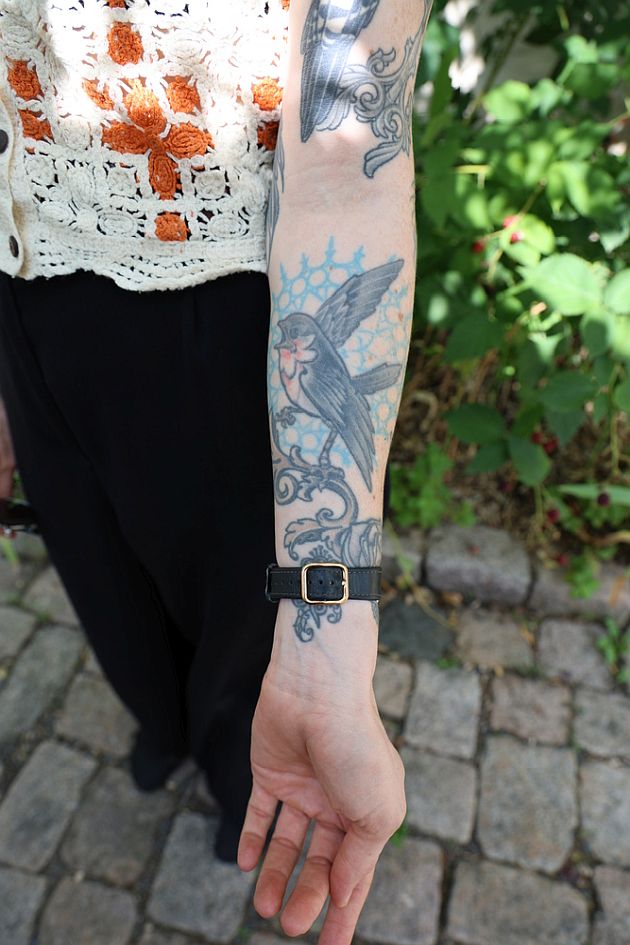 Laura Fella tattoos: The blue-and-black bird on her forearm