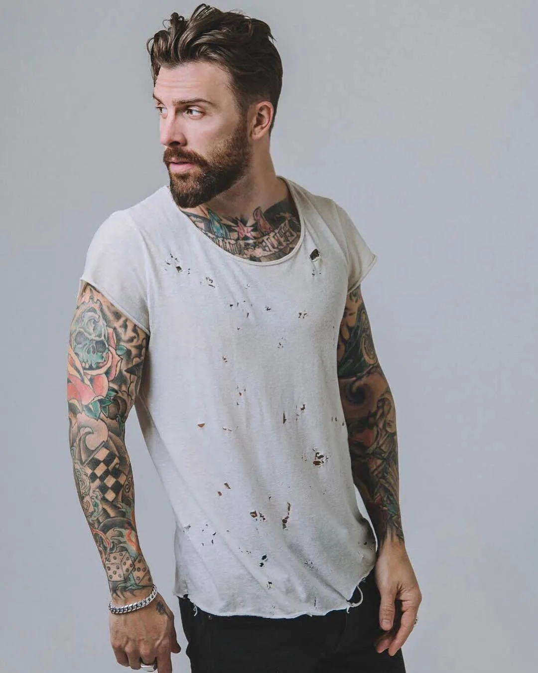 Levi Stocke tattoos: The green skull, red flower and checkerboard sleeve
