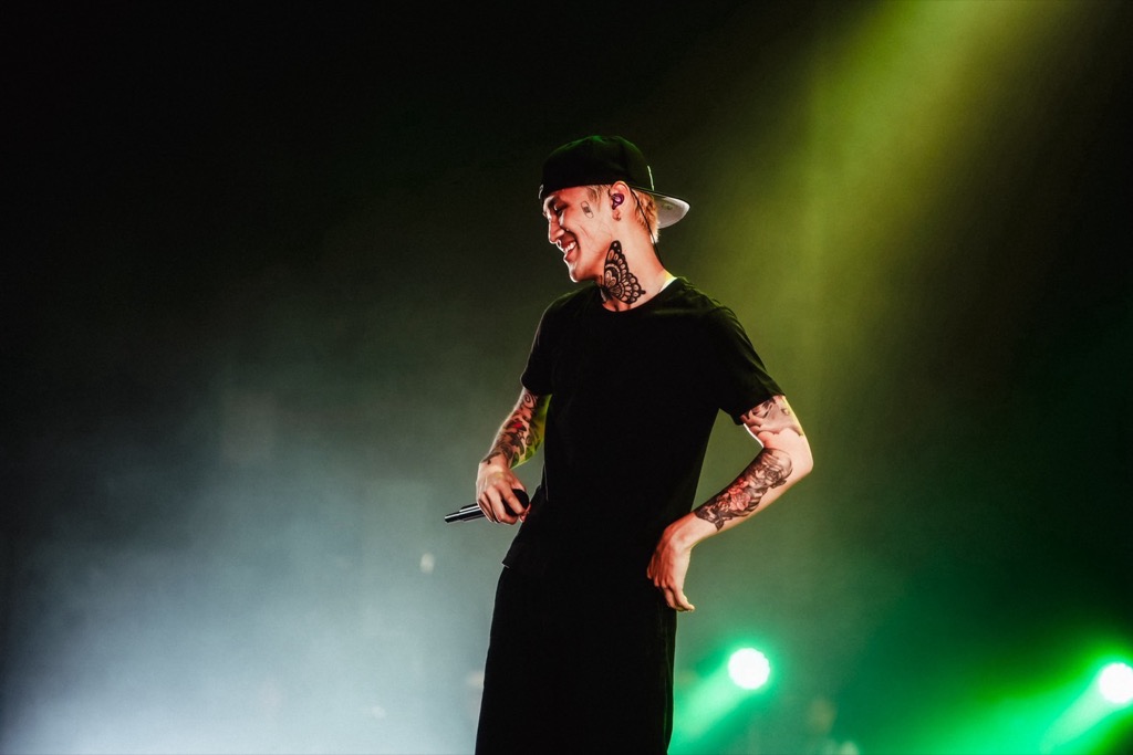 LEX A distinct live performance photograph with LEX's neck and forearm tattoos visible beside the name-and-year tattoo section LEX tattoos: A distinct live performance photograph with LEX's neck and forearm tattoos visible beside the name-and-year tattoo section