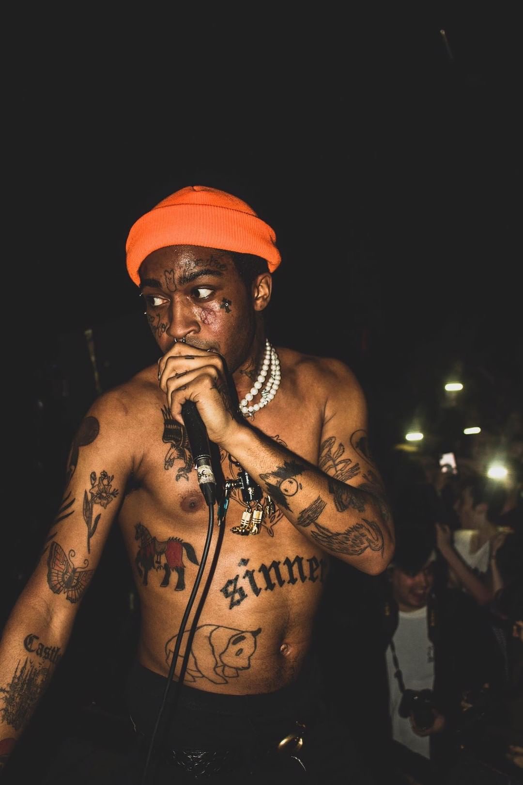 Lil Tracy tattoos: the sinner stomach lettering, chest drawings and extensive arm tattoos