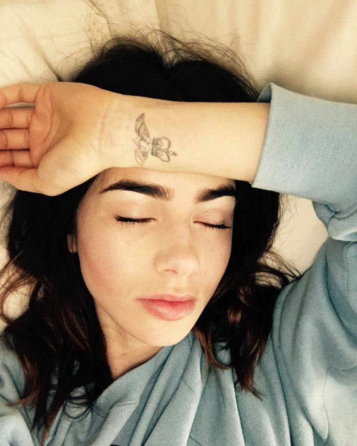 Lily Collins tattoos: fine-line butterfly wrist tattoo