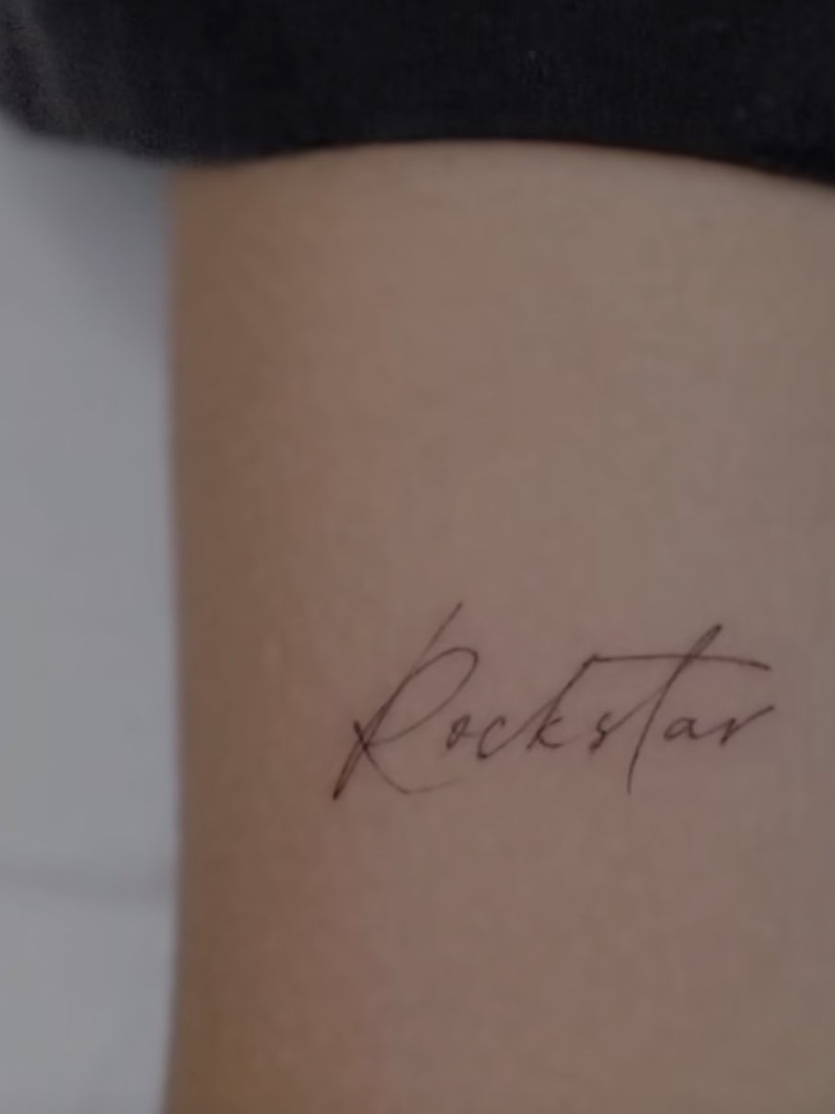 Lisa tattoos: arm lettering close-up
