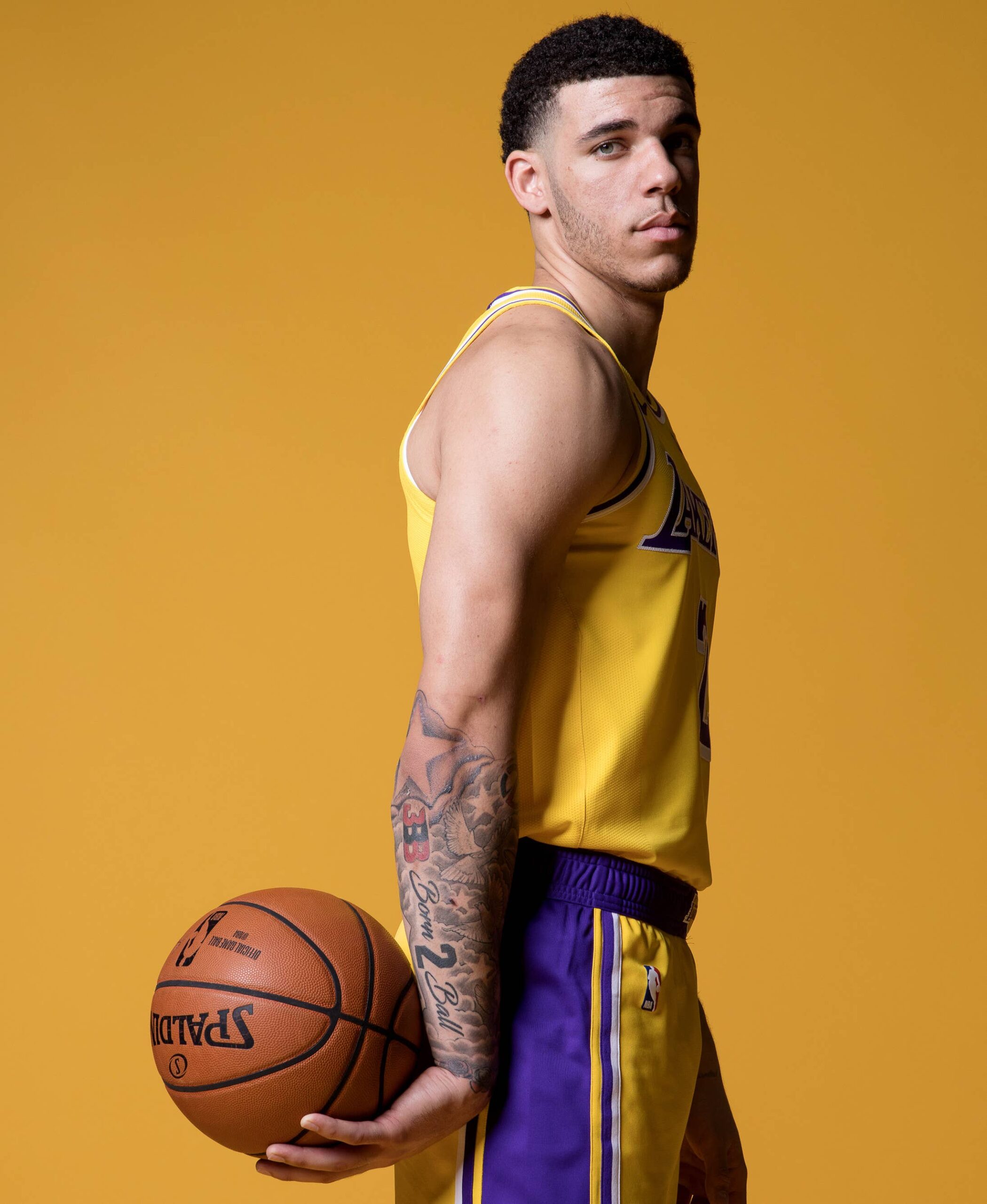 Lonzo Ball tattoos: Lakers portrait showing the forearm cover-up and Born 2 Ball lettering