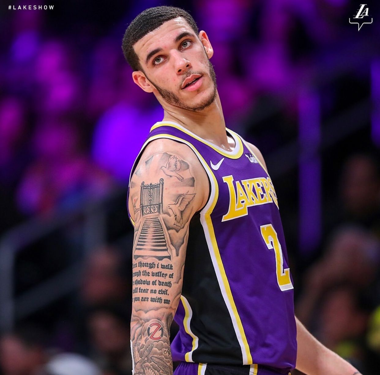 Lonzo Ball tattoos: Lakers action portrait showing the Psalm 23 sleeve and stairway design