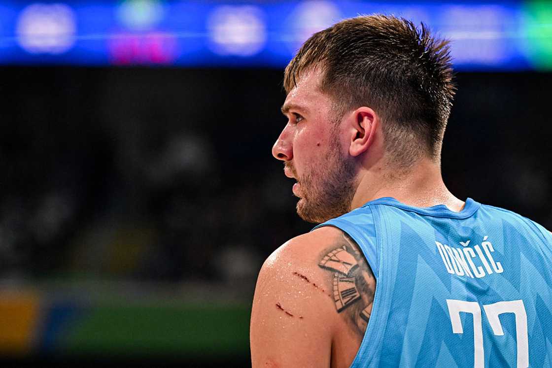 Luka Doncic tattoos: broken clock back tattoo