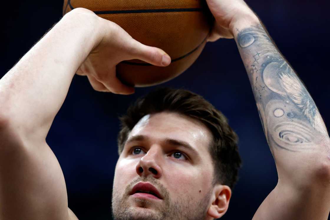 Luka Doncic tattoos: layered forearm sleeve tattoo