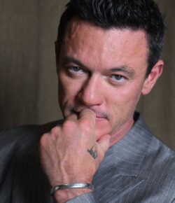 Luke Evans Tattoos: The Family Heartbeat Band and the Bird on His Thigh