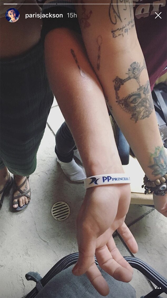 Macaulay Culkin and Paris Jackson showing their matching spoon tattoos in a close-up tattoo photo