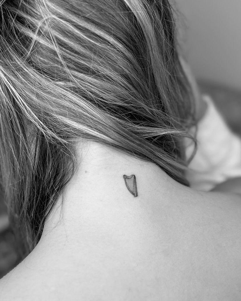 Madelyn Cline tattoos: Side-angle tattoo photograph showing the heart nape tattoo peeking below the hairline.