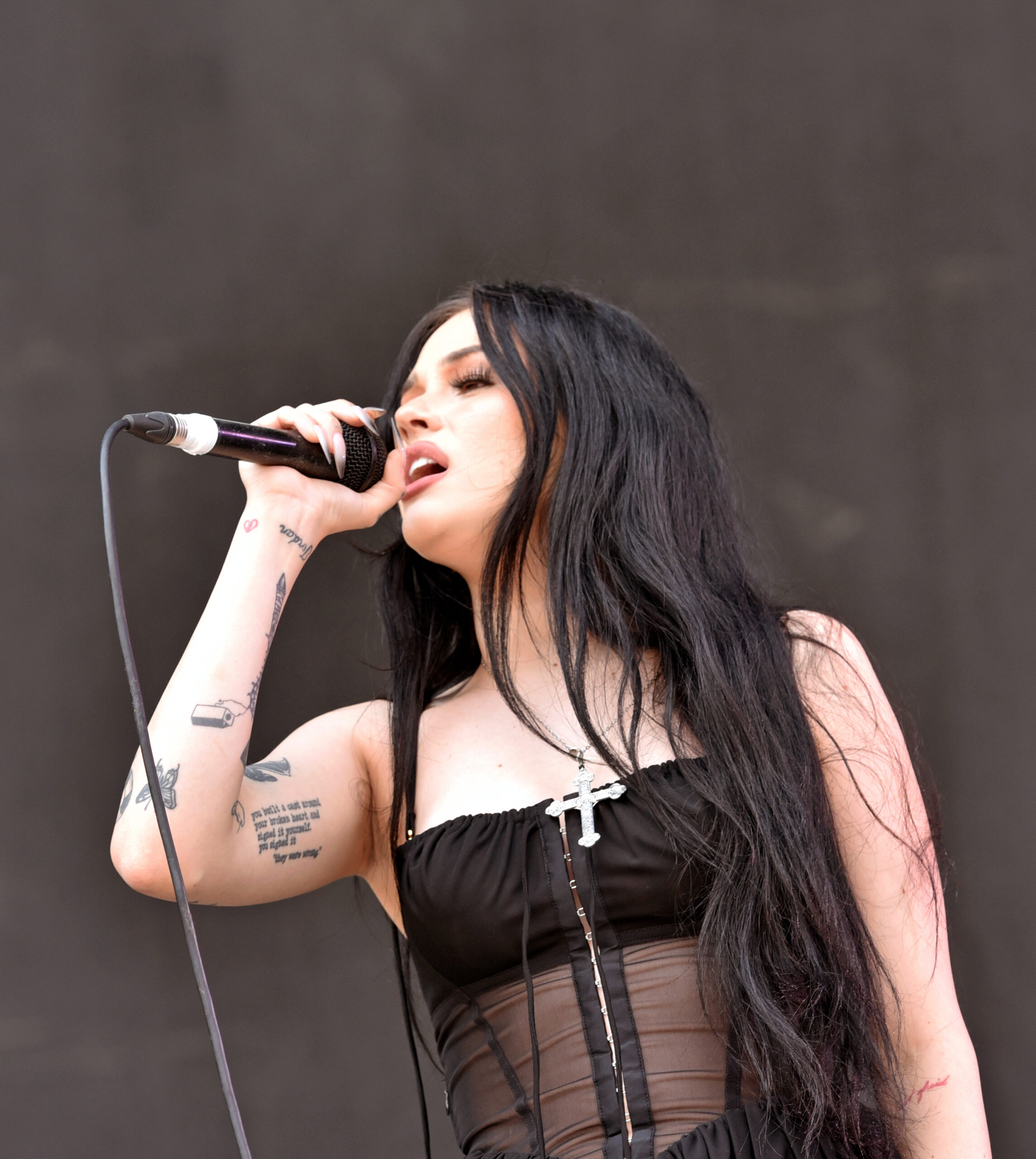 Maggie Lindemann forearm script and lettering tattoos