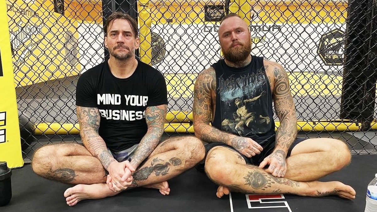 Malakai Black tattooed arms and legs with CM Punk