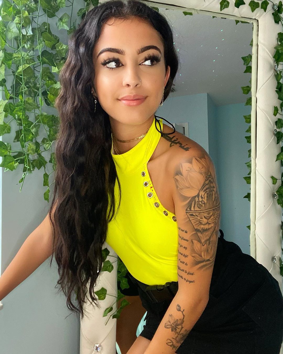Malu Trevejo tattoos: The tiger and flowers create the collection’s strongest vertical arm composition