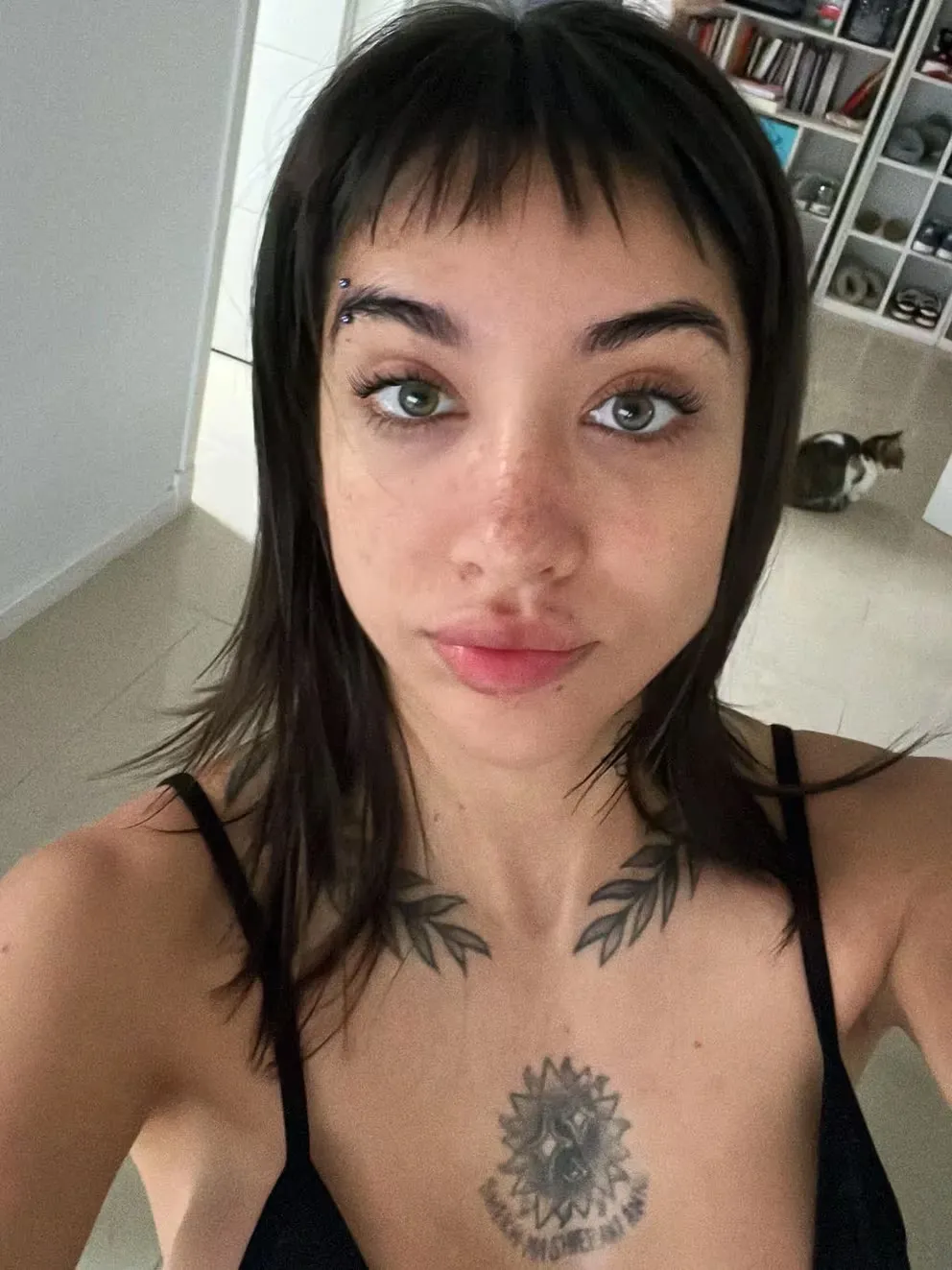 María Becerra tattoos: high-resolution candid portrait showing the Dothraki chest phrase and leaf branches without event styling