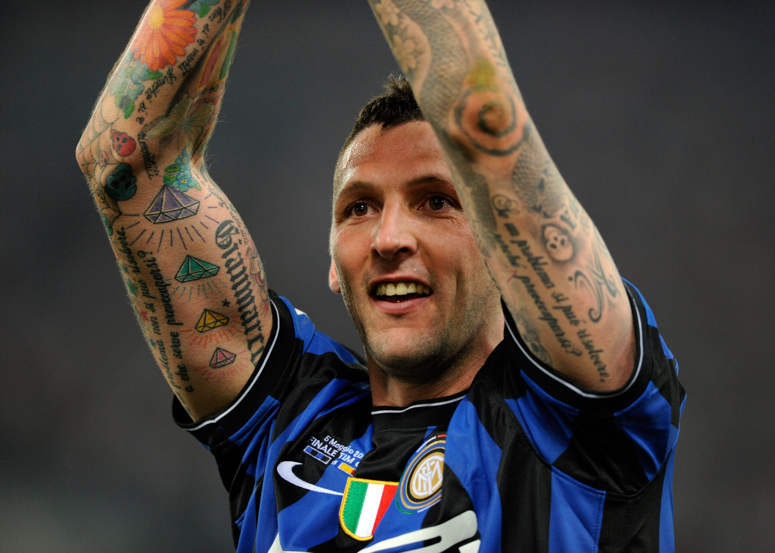 Marco Materazzi tattoos: Close celebration view of both raised tattooed forearms