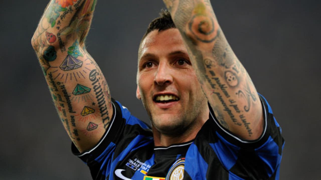 Marco Materazzi tattoos: Wide stadium context showing tattooed arms in motion