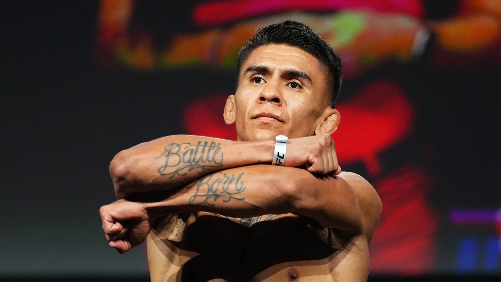 Mario Bautista tattoos: Battle Born across the forearms