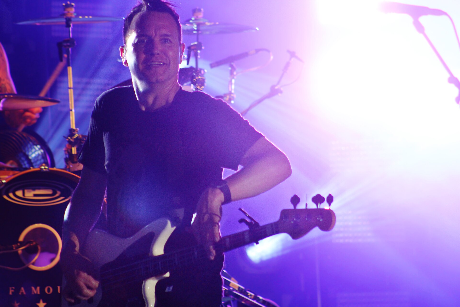 Mark Hoppus in a contextual photograph: music performance contextual photograph, no tattoo evidence; not tattoo evidence