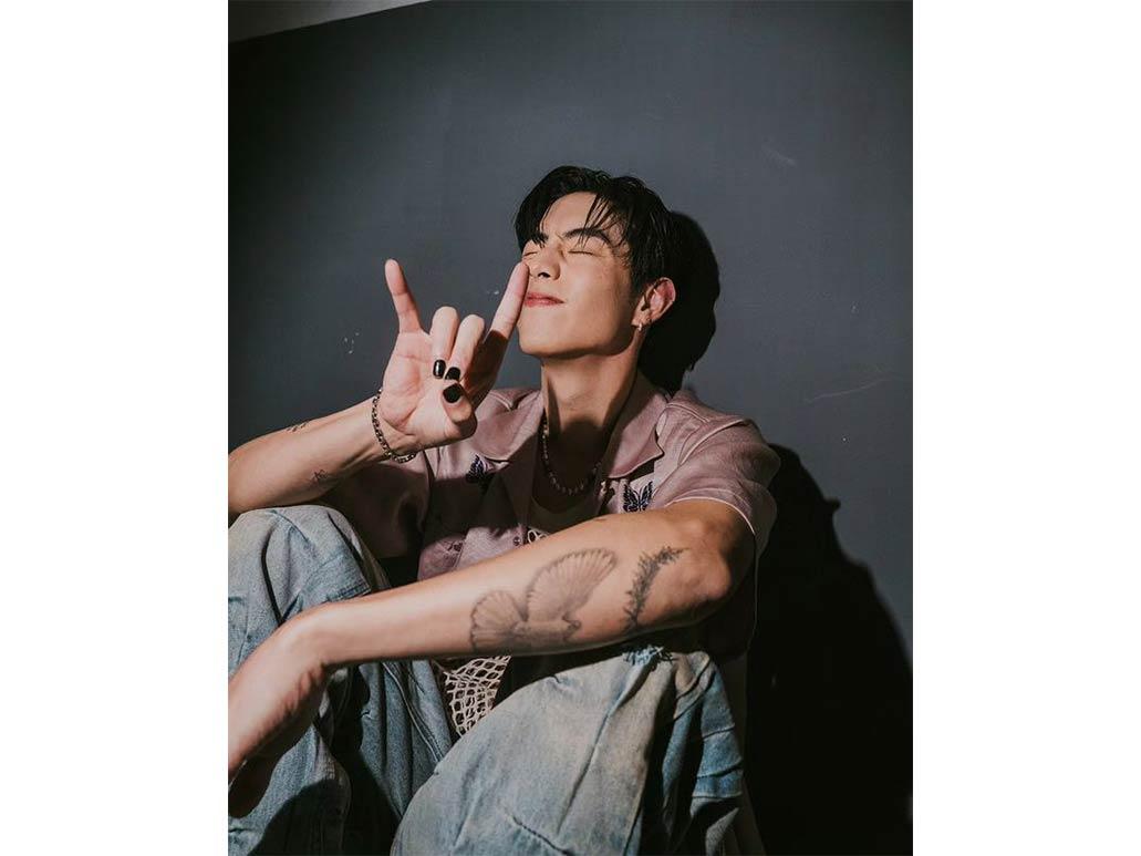 Mark Tuan tattoos: clean high-resolution portrait showing the flower, forearm linework and small arm symbols