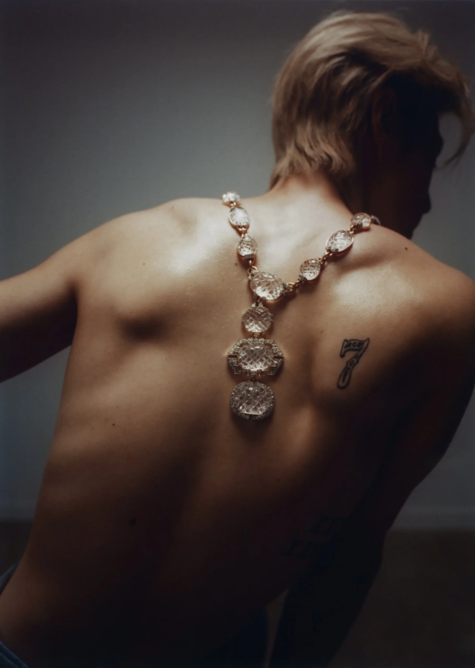 Mark Tuan tattoos: clean high-resolution portrait showing the GOT7 number 7 tattoo on the shoulder blade