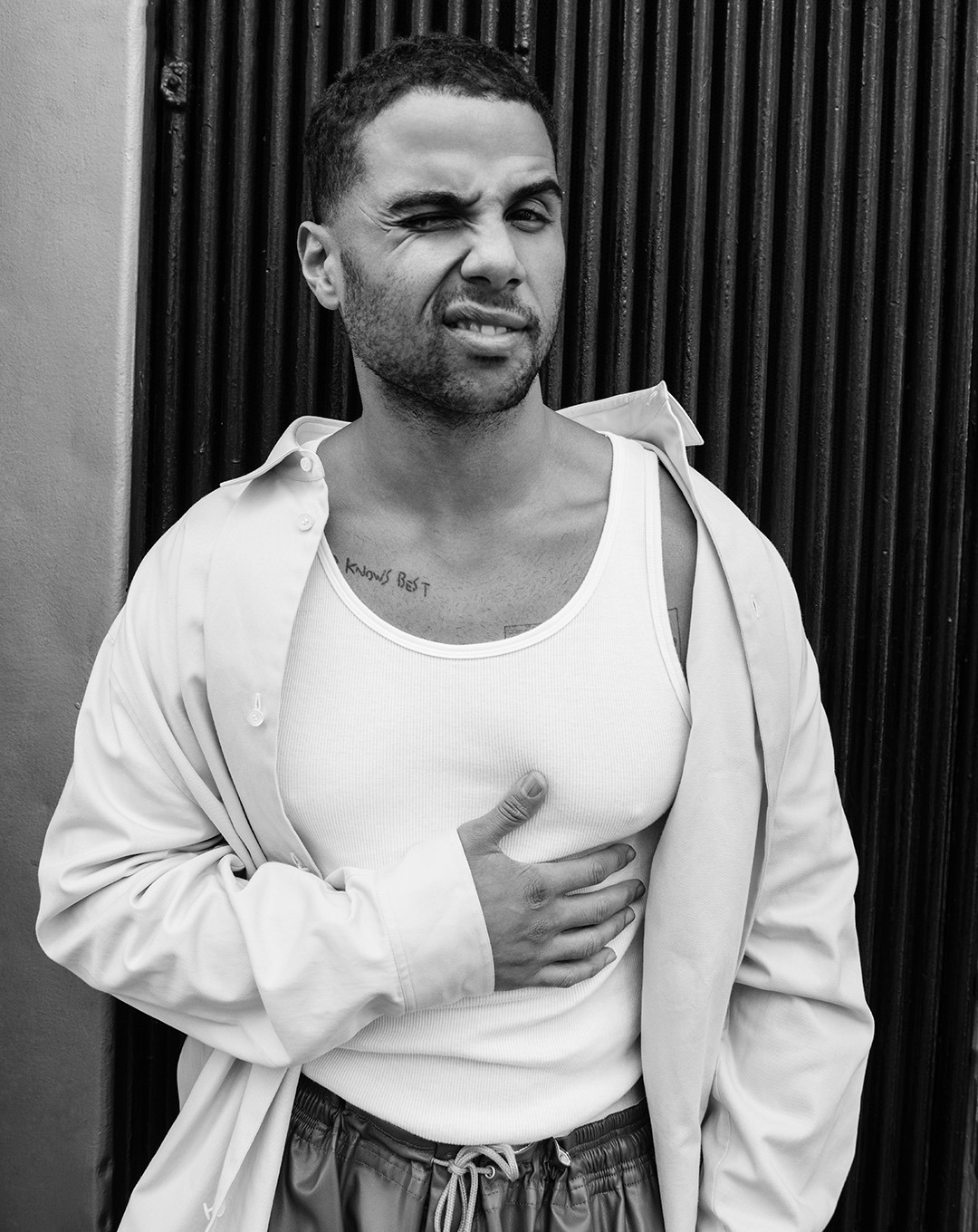 Mason Gooding tattoos: Genuine editorial tattoo photograph showing Mason Gooding's upper-chest lettering and adjacent body art.