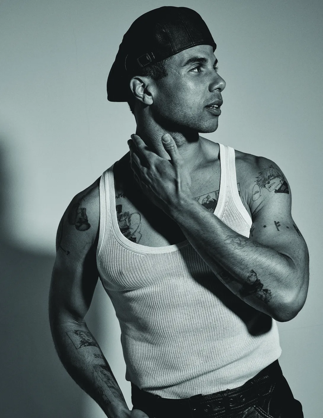 Mason Gooding tattoos: Genuine editorial tattoo photograph showing the back and shoulder artwork in a separate studio portrait.