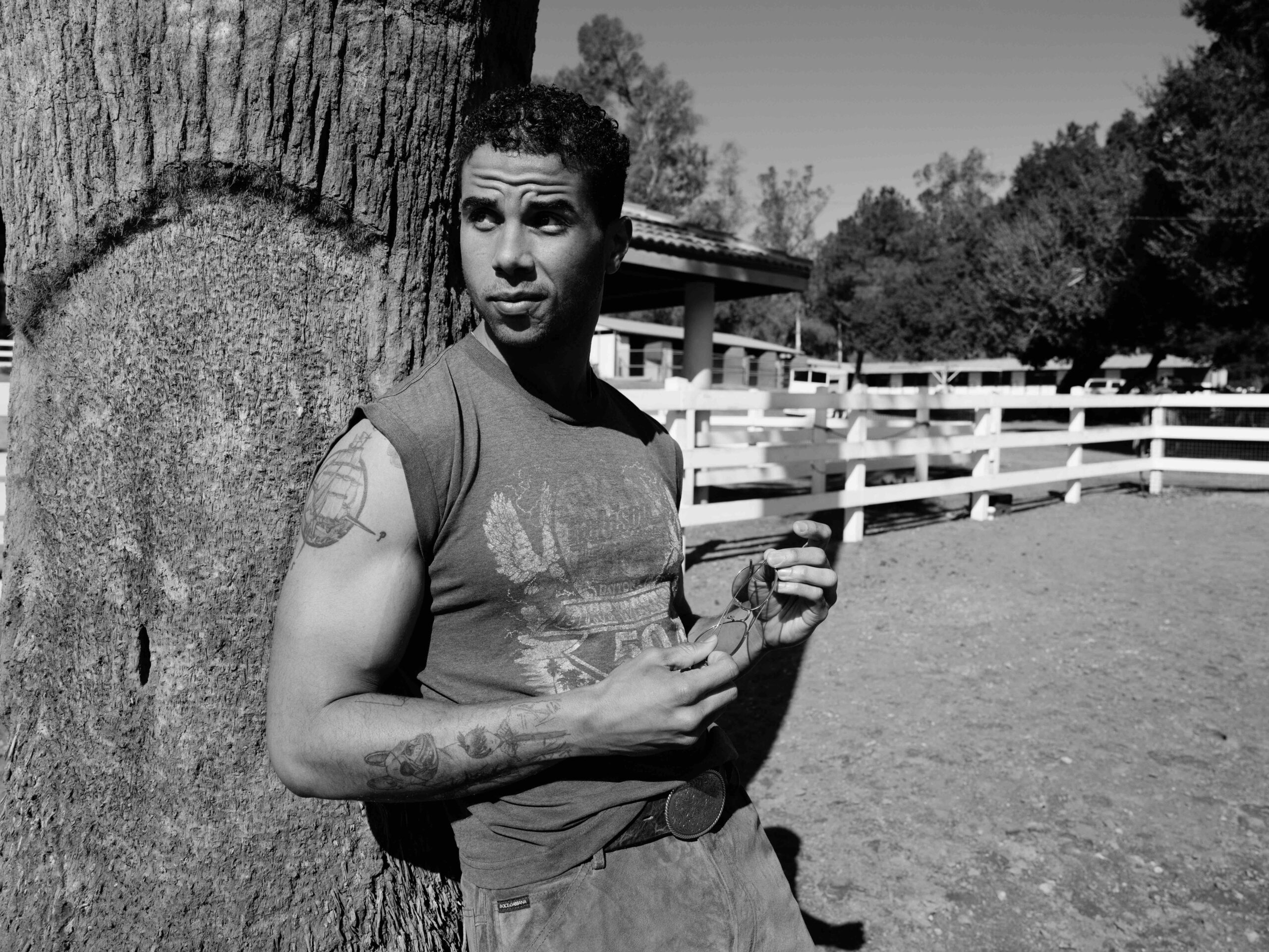 Mason Gooding tattoos: Genuine editorial tattoo photograph showing the upper-arm compass and ship design with additional forearm work.