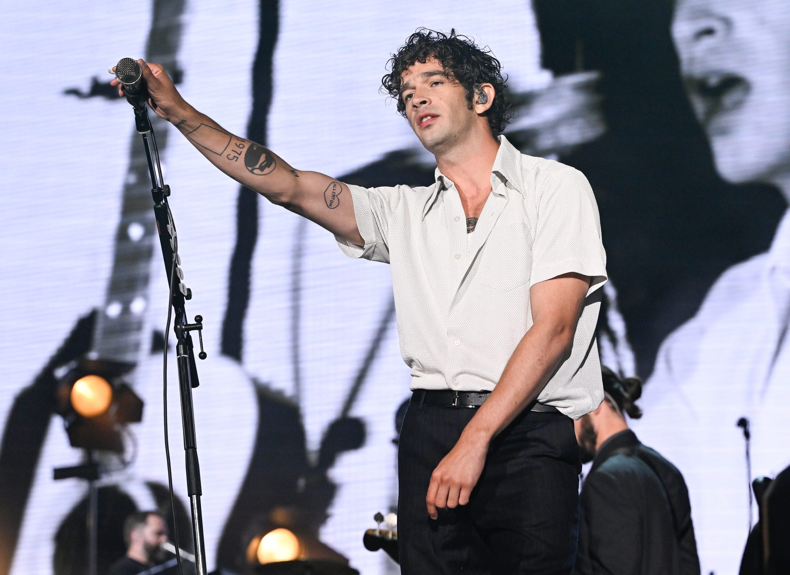 Matty Healy arm tattoos during a live performance