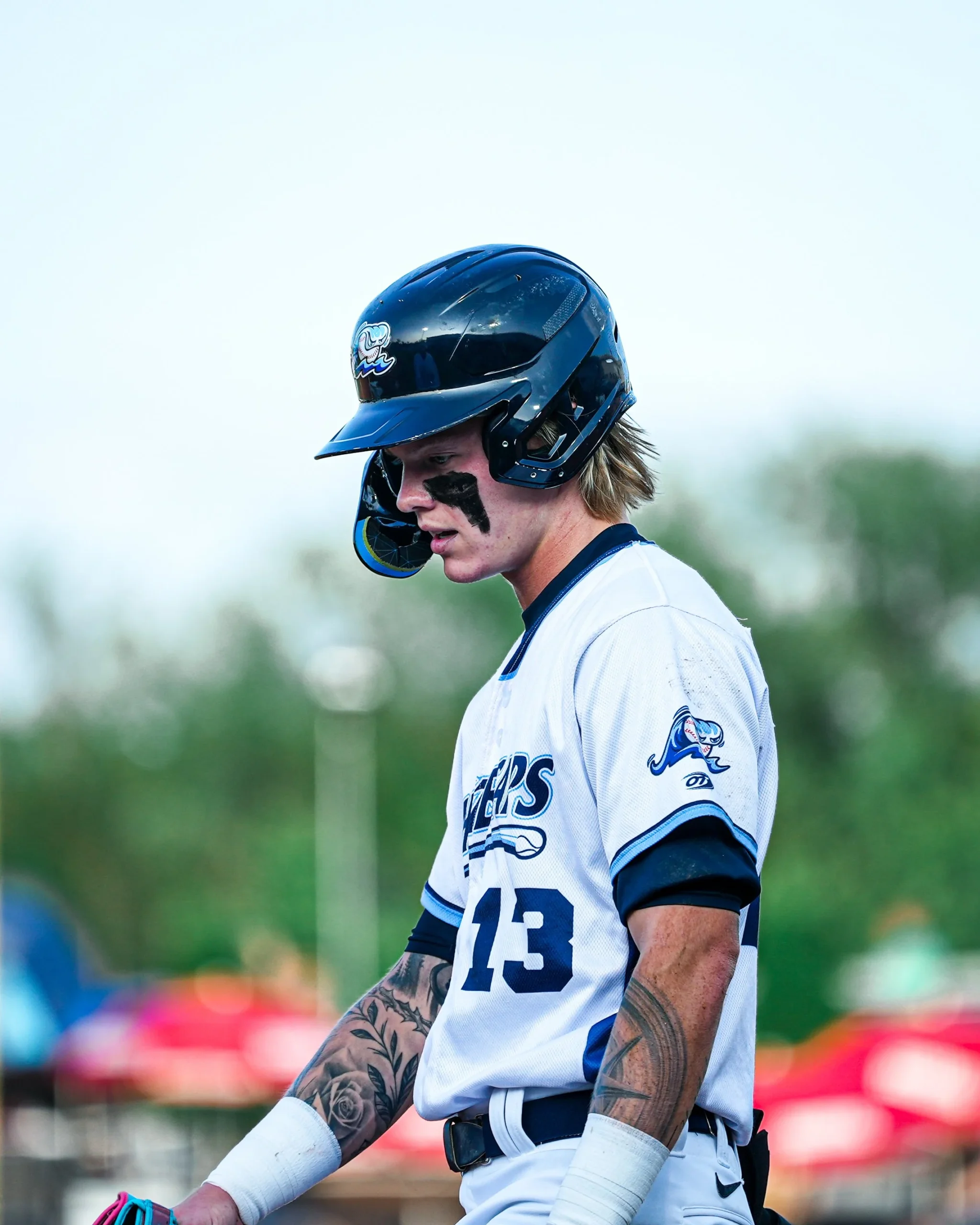 Max Clark tattoos: Max Clark’s forearm tattoos in a close seated portrait
