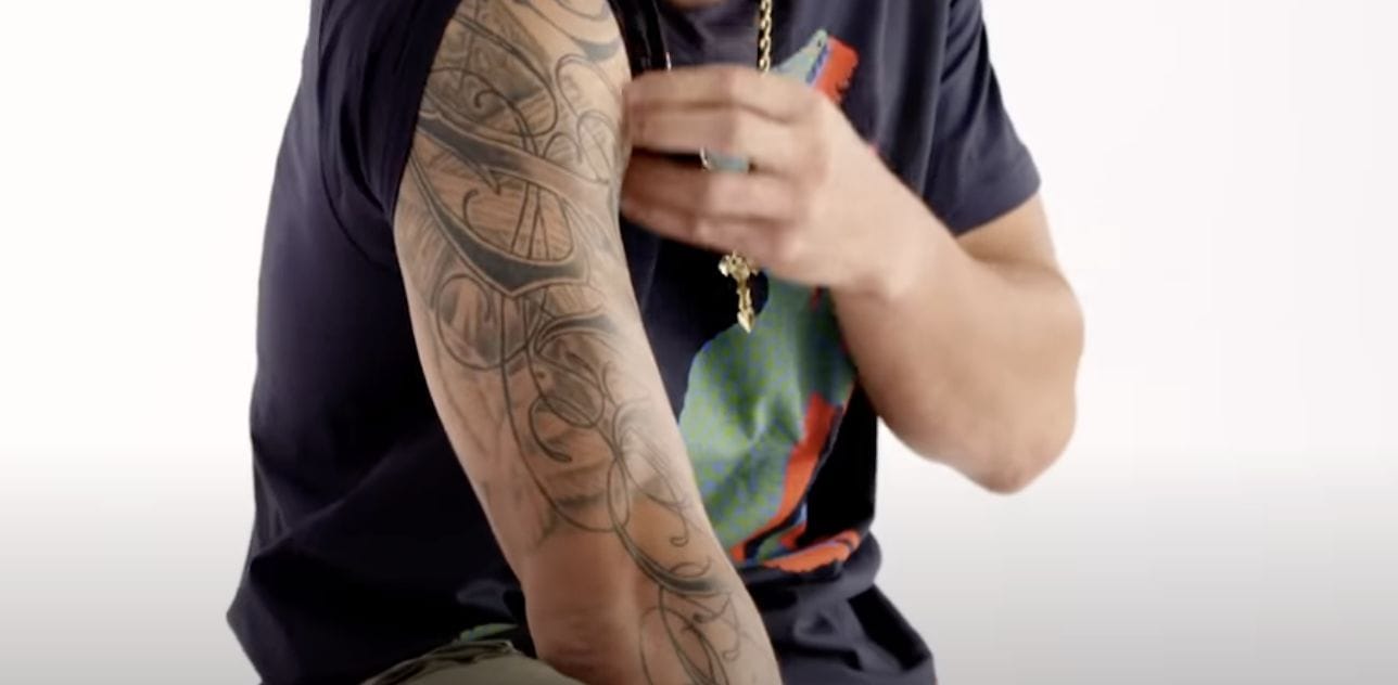 Max Holloway Polynesian Arm Pattern Tattoo Max Holloway tattoos: Sweeping Polynesian-style curves and pointed shapes extending along the arm