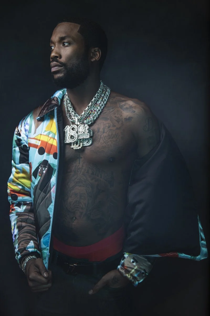 Meek Mill tattoos: Haute Living portrait showing the arm sleeve, chest lettering and shoulder work