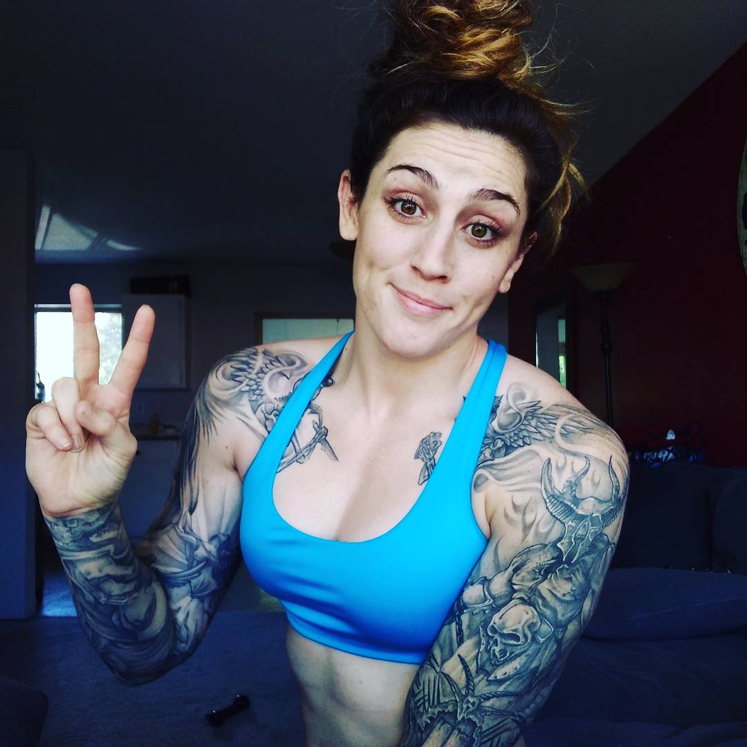 Megan Anderson tattoos: close personal view of the chest, shoulders and both full sleeves