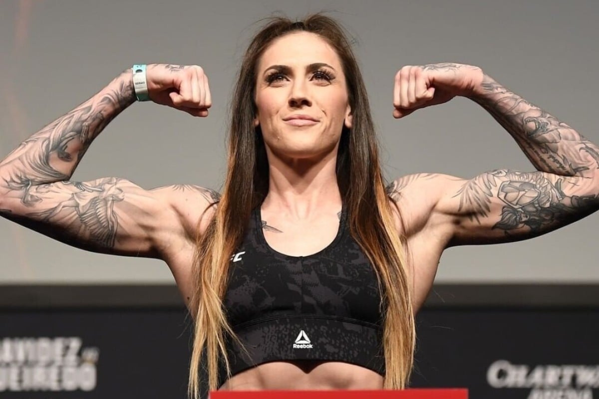 Megan Anderson tattoos: front weigh-in view showing both tattooed arms and upper-chest ink