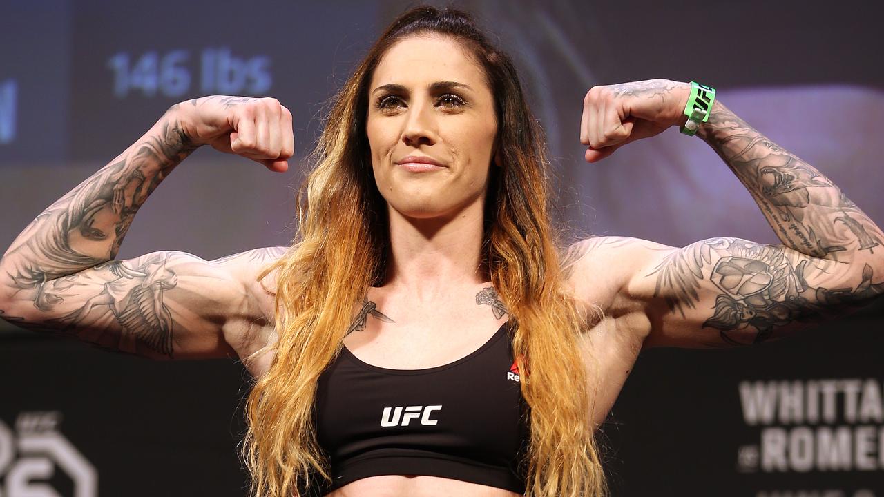 Megan Anderson tattoos: black sports-bra weigh-in view showing the upper-arm and shoulder layout