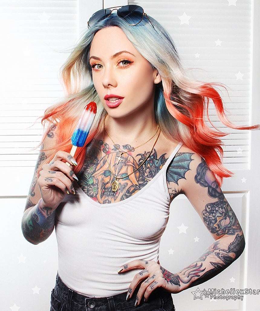 Megan Massacre tattoos: bright portrait showing the colorful chest and illustrative arm work