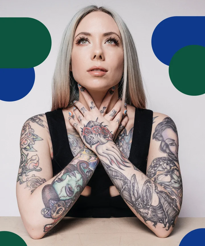 Megan Massacre tattoos: close portrait showing hand, finger, neck and chest tattoos