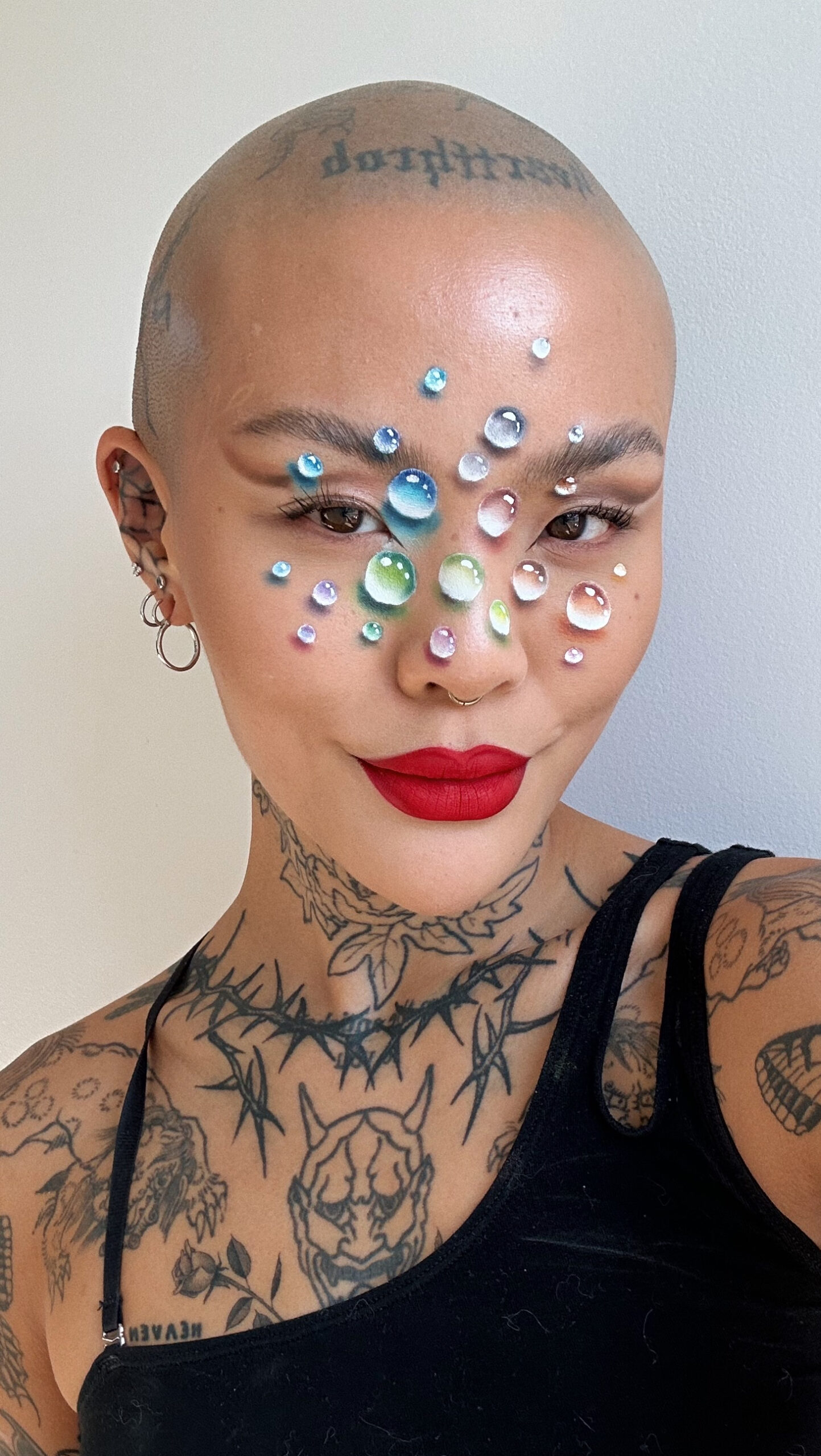 Mei Pang tattoos: close face-visible portrait showing neck, chest and shoulder tattoos