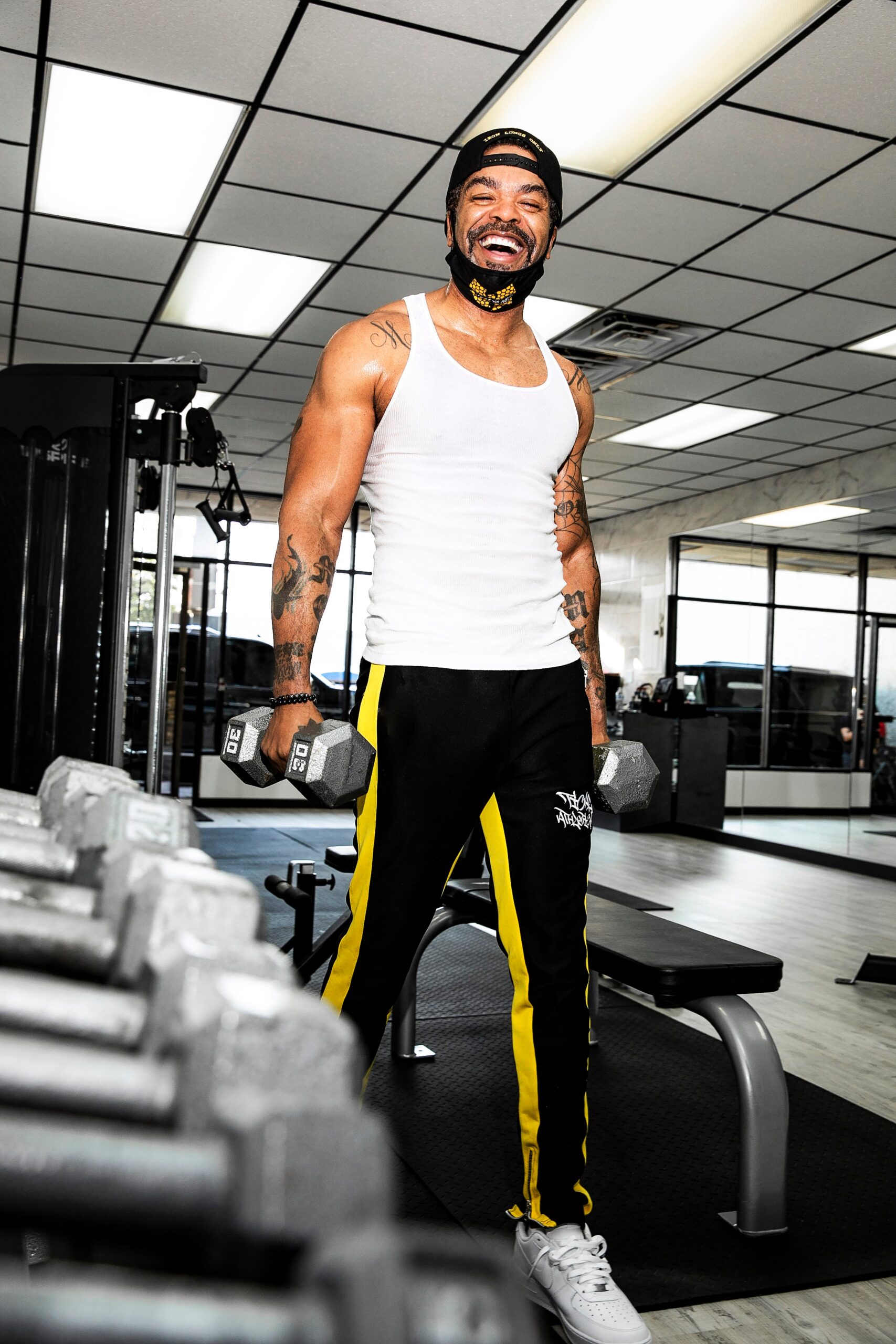 Method Man tattoos: large fitness portrait showing the chest, shoulders and arm tattoos in motion