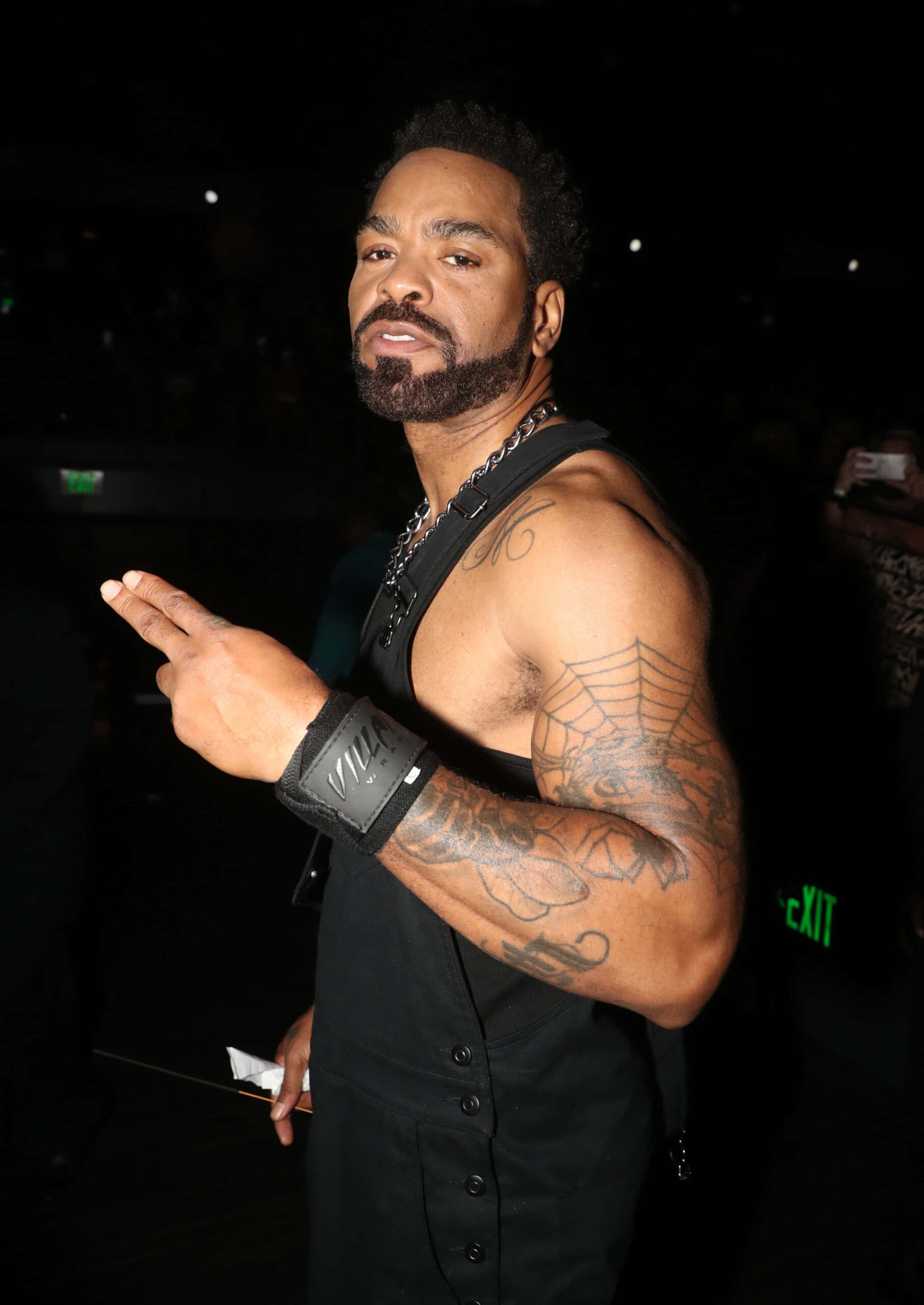 Method Man tattoos: high-resolution event portrait with the spiderweb and additional arm ink visible