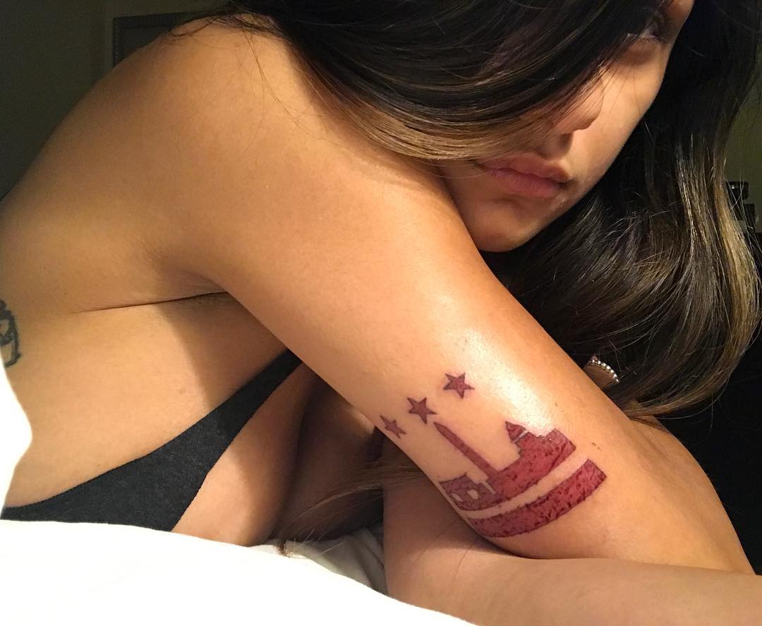 Mia Khalifa tattoos: map, stars, and small graphic marks on the arm
