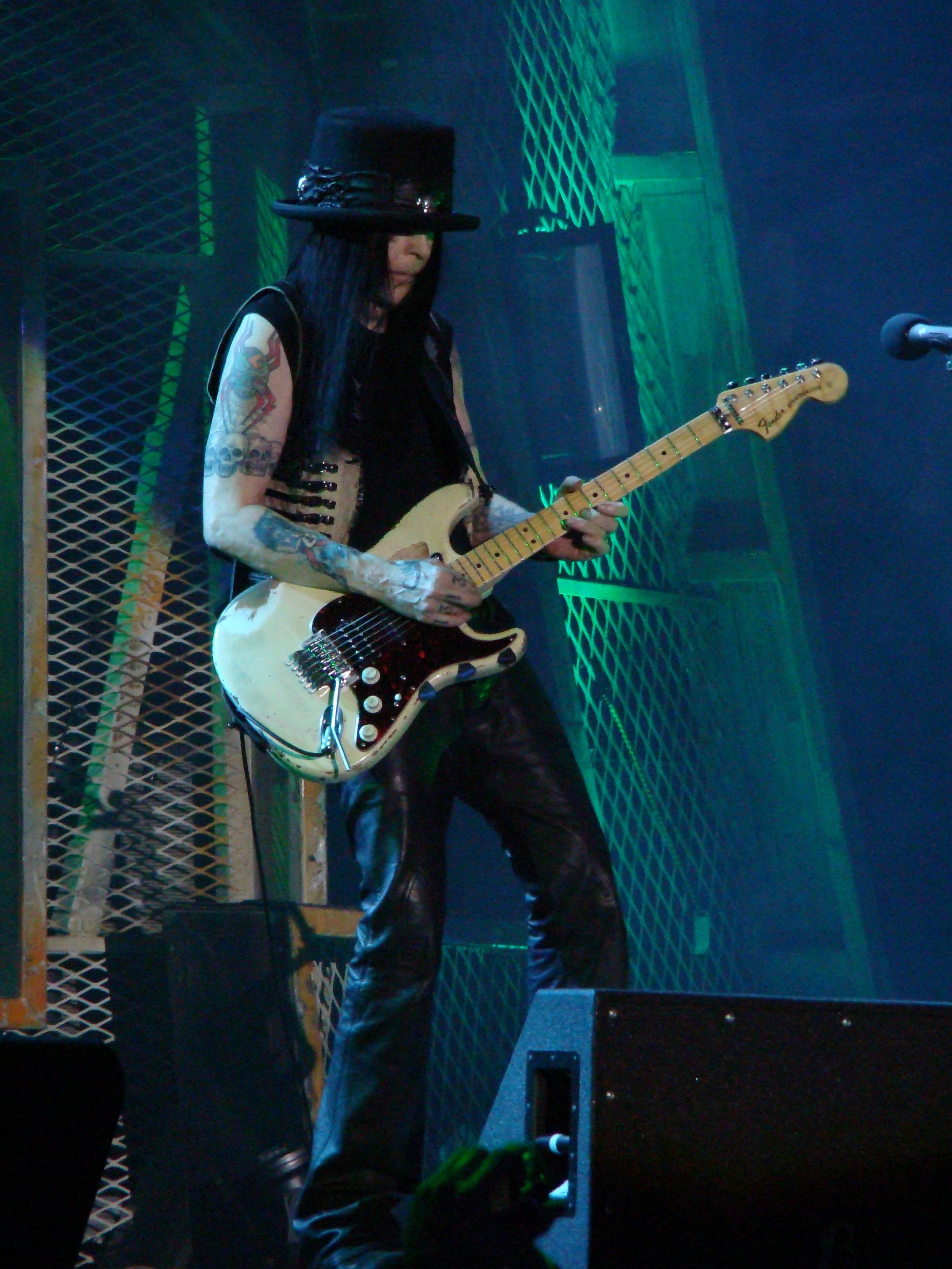 Mick Mars skull tattoos on both arms