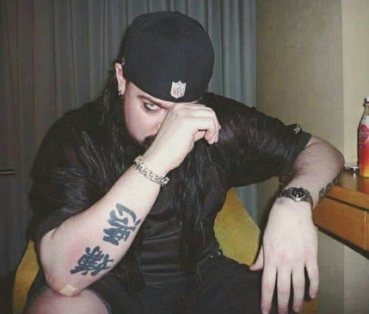 Mick Thomson arm tattoos seated