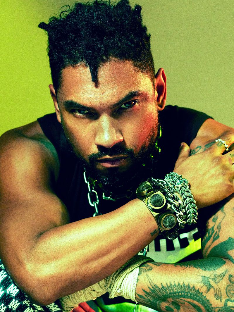 Miguel tattoos: forearm and shoulder tattoos in a close fashion editorial portrait