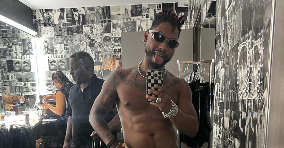Miguel tattoos: shirtless chest and arm tattoos in a clear mirror portrait